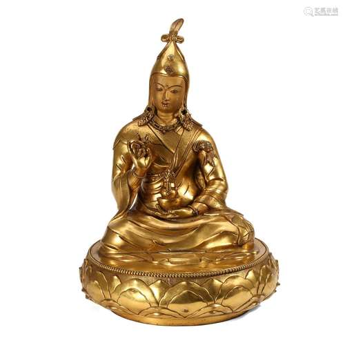 A GILT-BRONZE FIGURE OF A LAMA