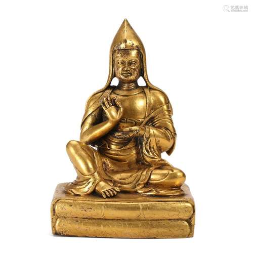 A GILT-BRONZE FIGURE OF A LAMA