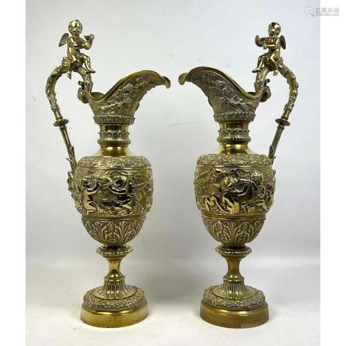 PR LARGE BRASS EWERS. ORNATE RELIEF OF CHERUBS AND FLOWERS. ...