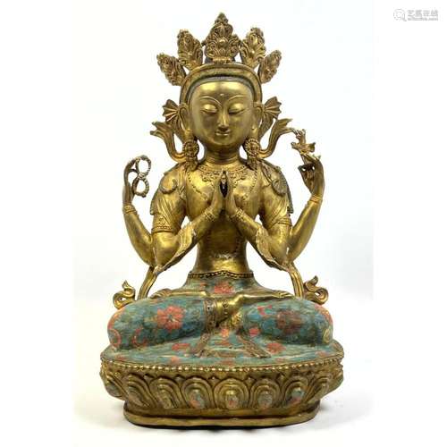 GILT METAL ASIAN GODDESS SEATED ON ENAMELED LOTUS BASE.