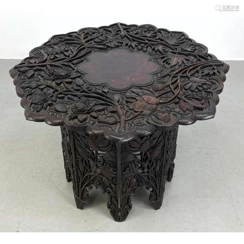 JUBBAR KAHN AND SONS HEAVILY CARVED TABLE WITH COLLAPSABLE B...