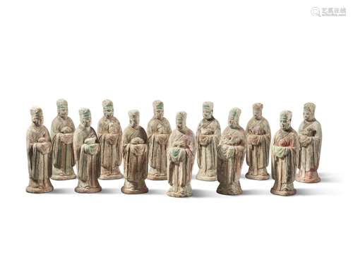 A set of twelve painted pottery figures of officials holding...