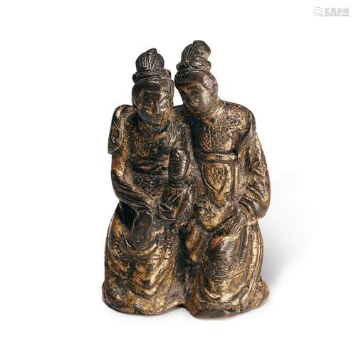 A gilt-bronze 'ladies and child' group, Ming dynasty...