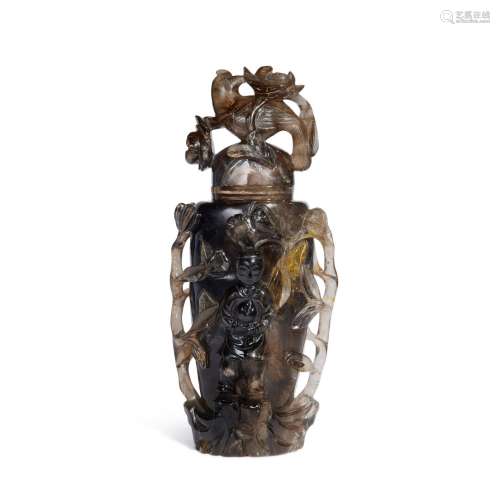 A smoky quartz 'boy and bird' vase and cover, 19th /...