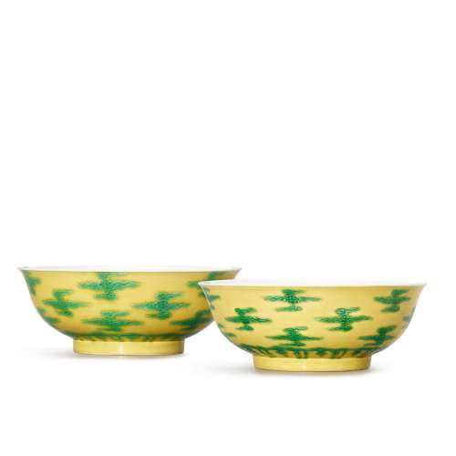 A pair of rare yellow-ground slip-decorated green-enamelled ...