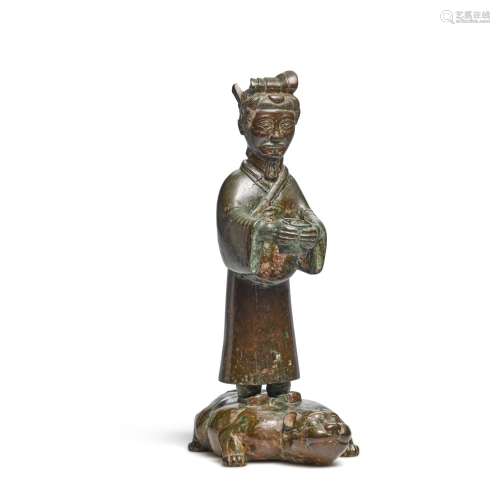 A bronze figure standing on a crouching beast, Eastern Zhou ...