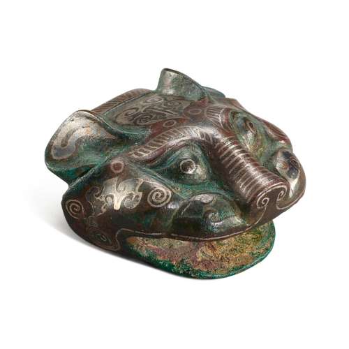 A silver-inlaid bronze 'tiger head' ornament, Eastern Zhou d...