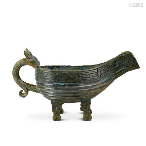 An inscribed archaic bronze pouring vessel, yi, Zhou dynasty...