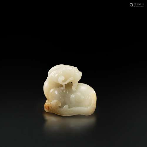 A white and russet jade 'mythical beast and lingzhi' group, ...