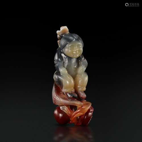 An inscribed three-colour agate figure of a boy, Qing dynast...
