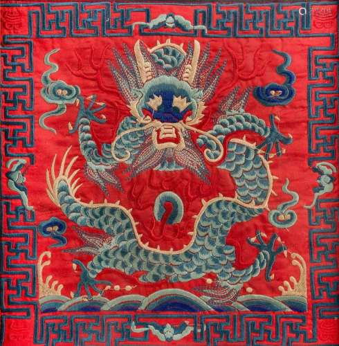 A farmed red ground embroidery depictng an Imperial dragon. ...