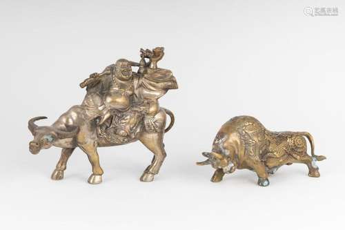 A cast brass happy Buddha seated upon a buffalo,