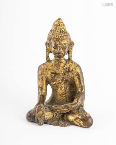 A gilt bronze statue of Gautama Buddha.