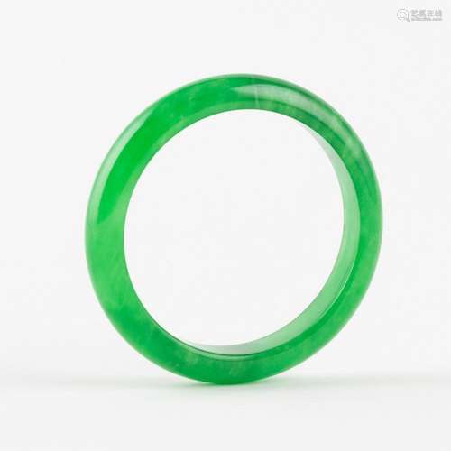 A spinach green jadeite bangle. 2 1/2 in. (6.35 cm.) inner d...