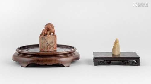 A Chinese carved lion seal stone with a rectangular base, li...