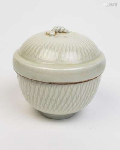 A creamy white glazed covered jar. 4 in. (10 cm) h.