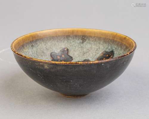 A dark glazed wine bowl,