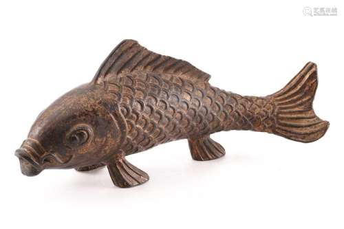 A Chinese bronze carp, the scaley body supported by the pelv...