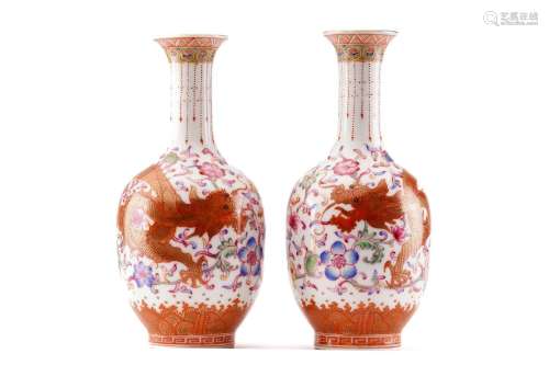 A pair of Chinese porcelain dragon vases, the red dragon hig...