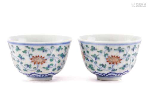 A pair of Chinese Wucai tea bowls, painted with lotus flower...