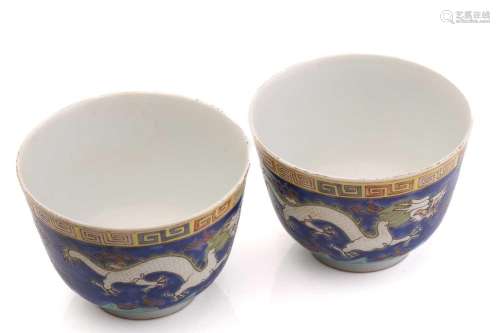 A pair of Chinese porcelain dragon cups, painted with opposi...