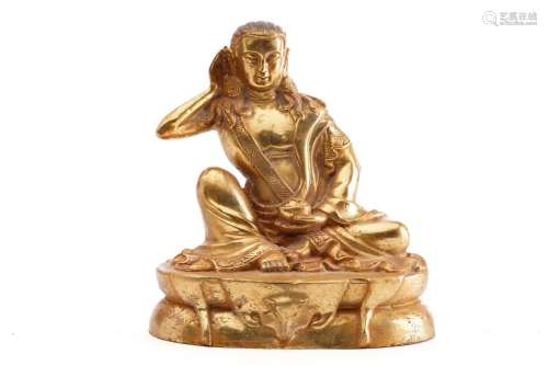 A Chinese gilt bronze figure of Milarepa, seated with his ri...