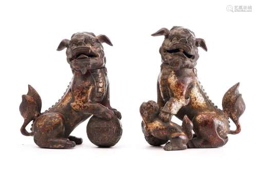 A pair of Chinese bronze censors in the form of temple lions...