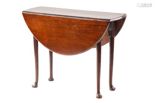 A George III mahogany gateleg table, the oval top on turned ...