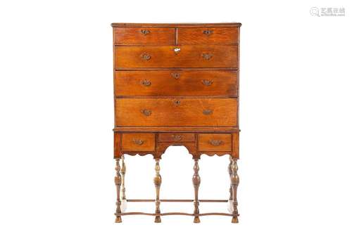 An 18th century oak chest on later stand, the moulded edge t...