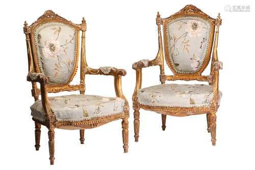 A pair of Louis XVI-style carved wood and gilt gesso fauteui...
