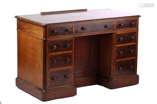 A late Victorian mahogany kneehole pedestal writing desk, th...