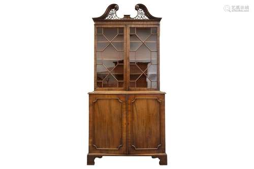 A George III mahogany cupboard bookcase with a carved and la...