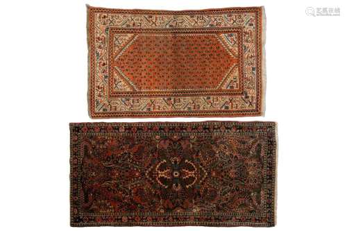 A small Sarouk rug with a distinctive pink ground with a cen...