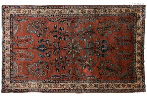 An old silk Kashan rug with stylized shrubs and flowers on a...