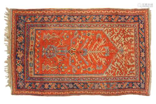 An old Turkish Ushak rug with a stylized tree of life design...