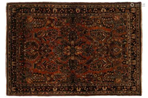 An old sarouk rug with a central medallion and floral sprays...