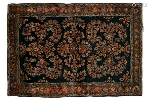 An old Sarouk rug with floral sprays on an indigo blue groun...