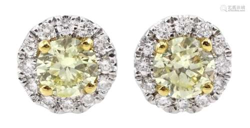 Pair of 18ct white gold round brilliant cut fancy yellow and...