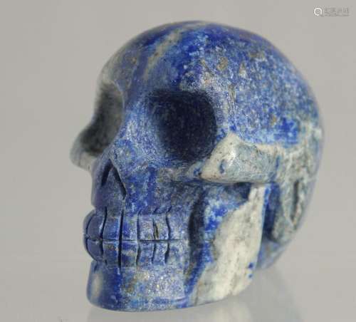 A CARVED LAPIS SKULL 2ins high.