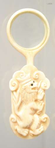 A CARVED BONE LOOKING GLASS.