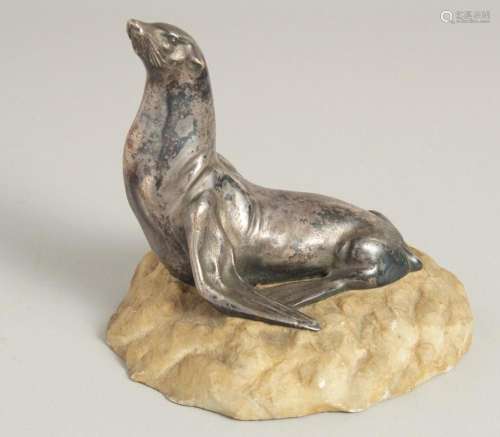 MOREAUX. A MODEL OF A SEA LION on a stone base. Signed. 5ins...