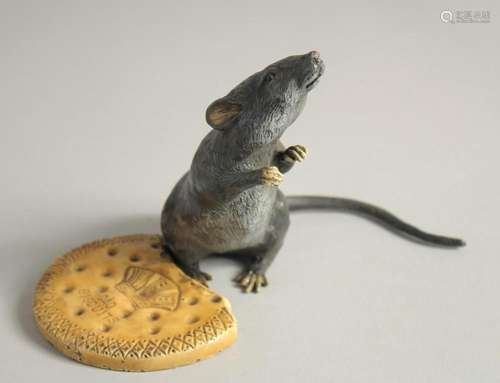 A COLD CAST MODEL OF A RAT standing beside a biscuit. 4.5ins...