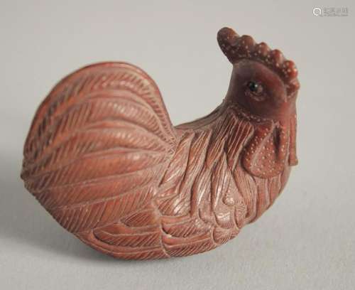 A WOODEN NETSUKE OF A CHICKEN. Signed, 2ins long.