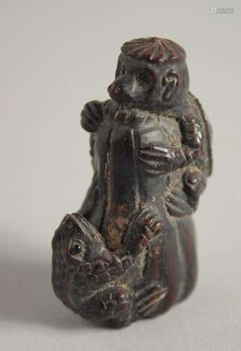 A WOODEN NETSUKE OF A FROG. 2ins