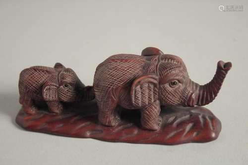 A JAPANESE CARVED WOOD ELEPHANT AND YOUNG. Signed, 4.5ins lo...