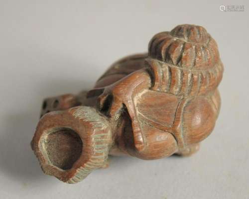 A JAPANESE CARVED WOOD SKULL NETSUKE Signed.