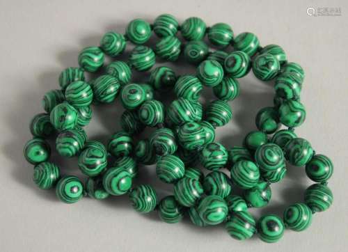 A STRING OF MALACHITE BEADS. 19ins long.