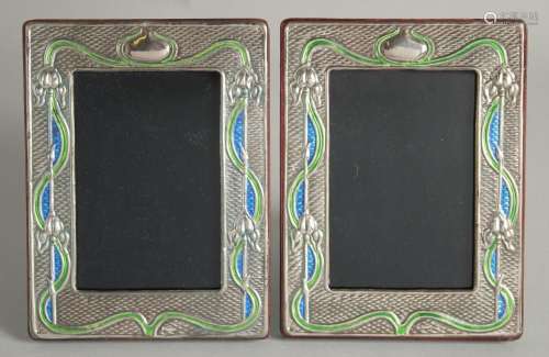 A PAIR OF SILVER AND ENAMEL PHOTOGRAPH FRAMES. 7.5ins X 5.5i...