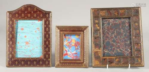 THREE TOOLED MOROCCAN LEATHER PHOTOGRAPH FRAMES. 8ins x 7ins...