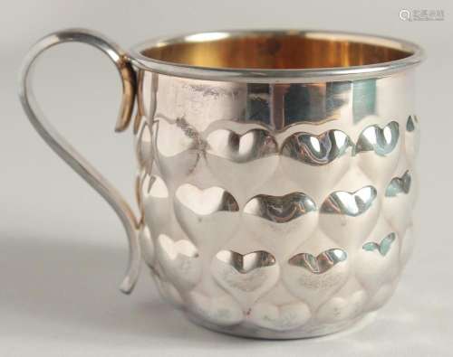 A TIFFANY & CO. SILVER CUP in a Tiffany & Co. bag.